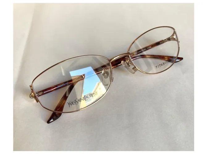Yves Saint Laurent Monturas de titanio YSL Gold hardware 